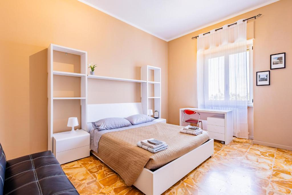 um quarto com uma cama e um sofá em Casa Lungogesso em Cuneo