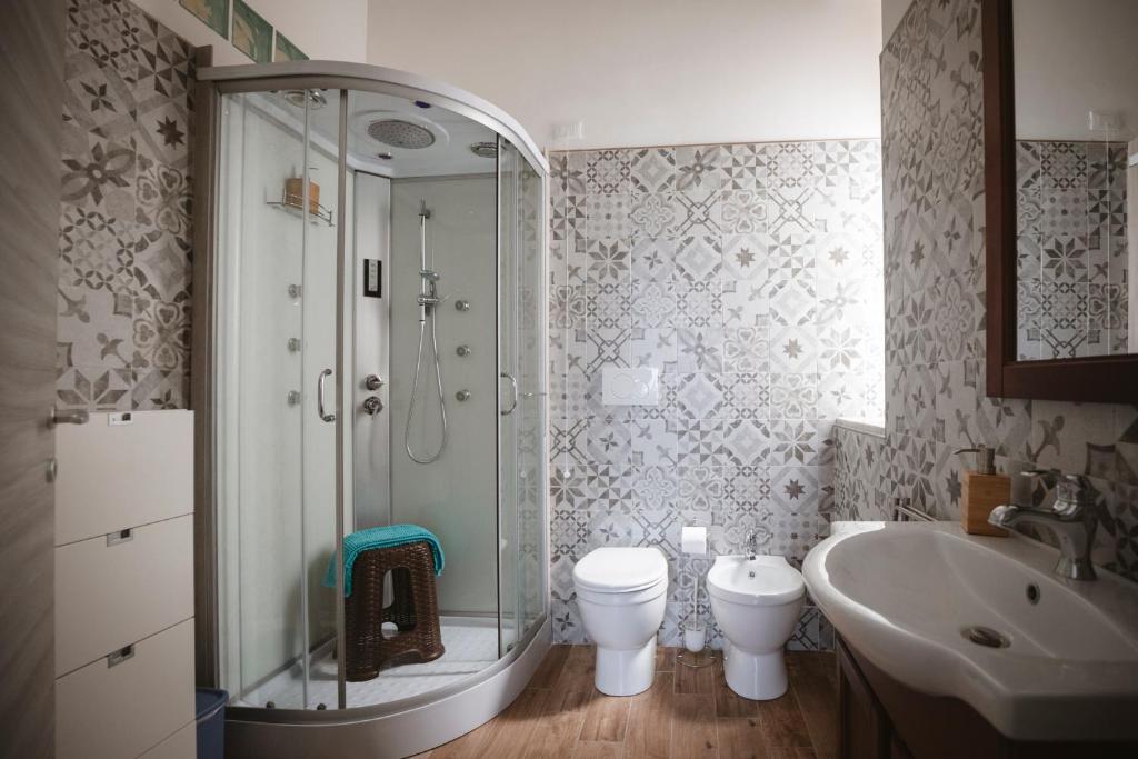 a bathroom with a shower and a toilet and a sink at Villa Valentina Versilia in Viareggio