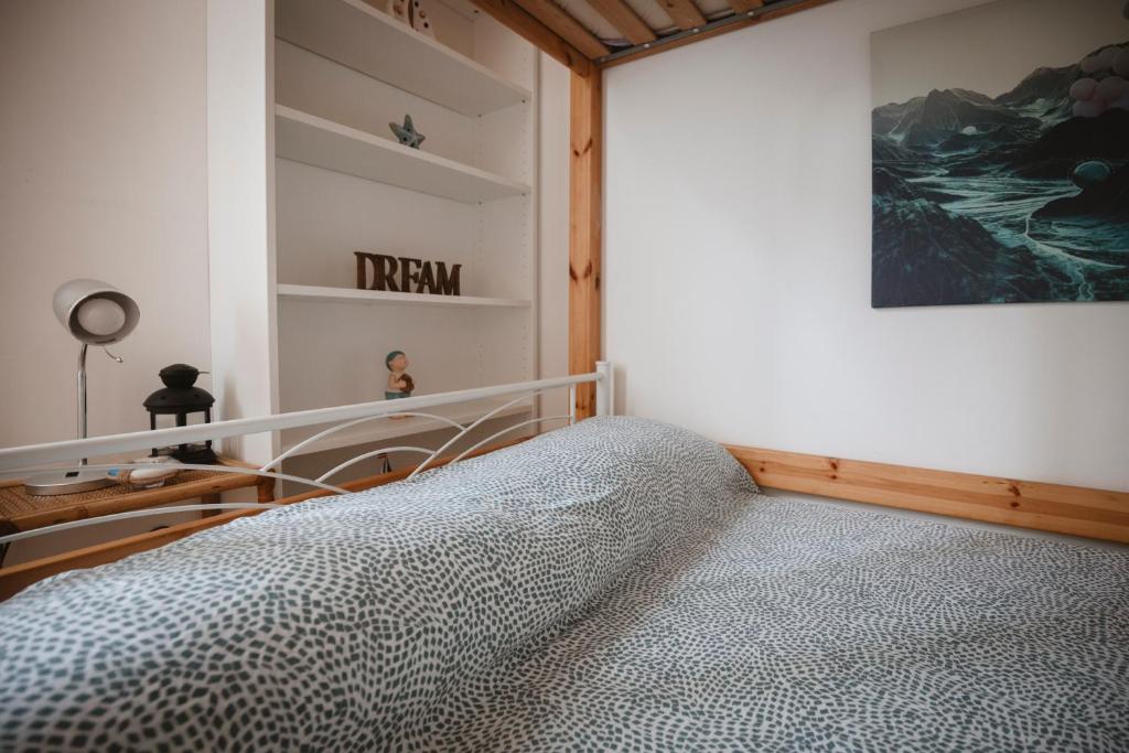a bedroom with a bed and a painting on the wall at Villa Valentina Versilia in Viareggio