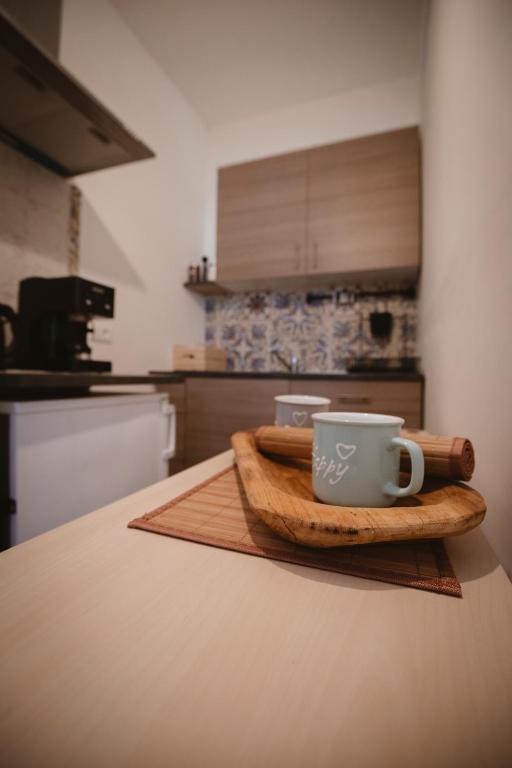 a coffee cup on a wooden tray on a kitchen counter at Villa Valentina Versilia in Viareggio