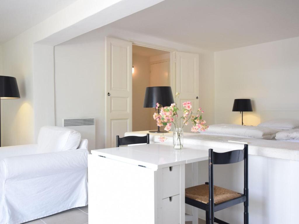 a room with a white desk and two beds at Apartment in Montbrun les Bains near forest in Reilhanette