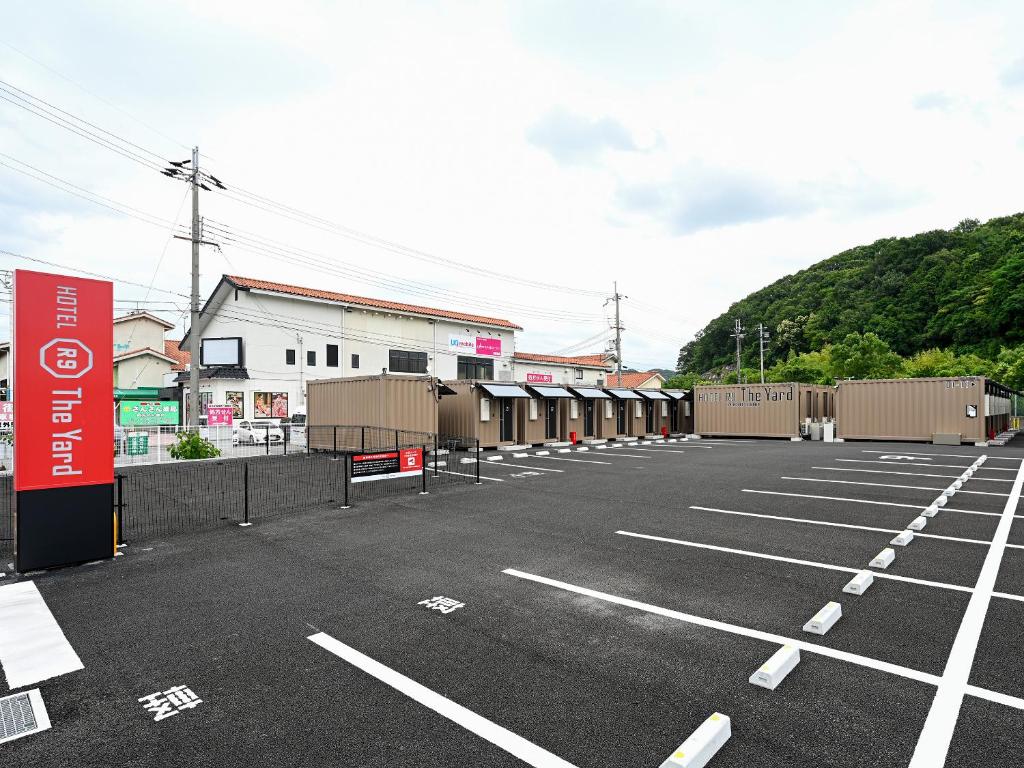 a parking lot with a bunch of cars in it at HOTEL R9 The Yard Kasai in Kasai