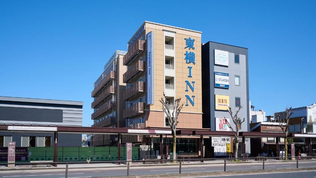 a tall building on a street in a city at Toyoko Inn Kintetsu Nara Ekimae in Nara