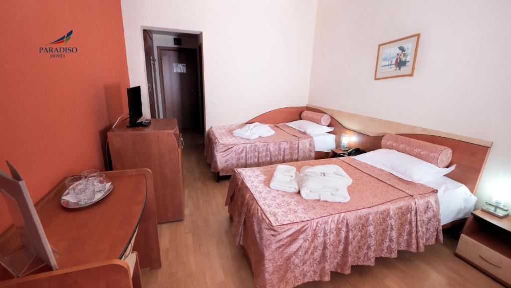 Postel nebo postele na pokoji v ubytování Hotel Paradiso