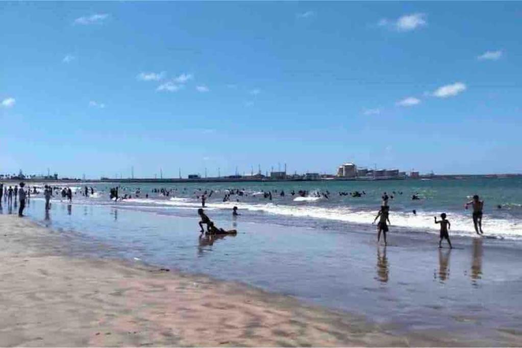 a group of people playing in the water at the beach at Villa 471 m2 sur la plage in Mohammedia