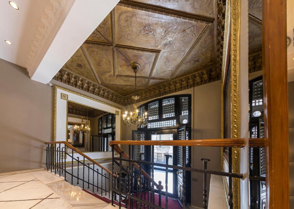 a hallway with a coffered ceiling and a staircase at Vardar Palace Hotel - Special Category in Istanbul