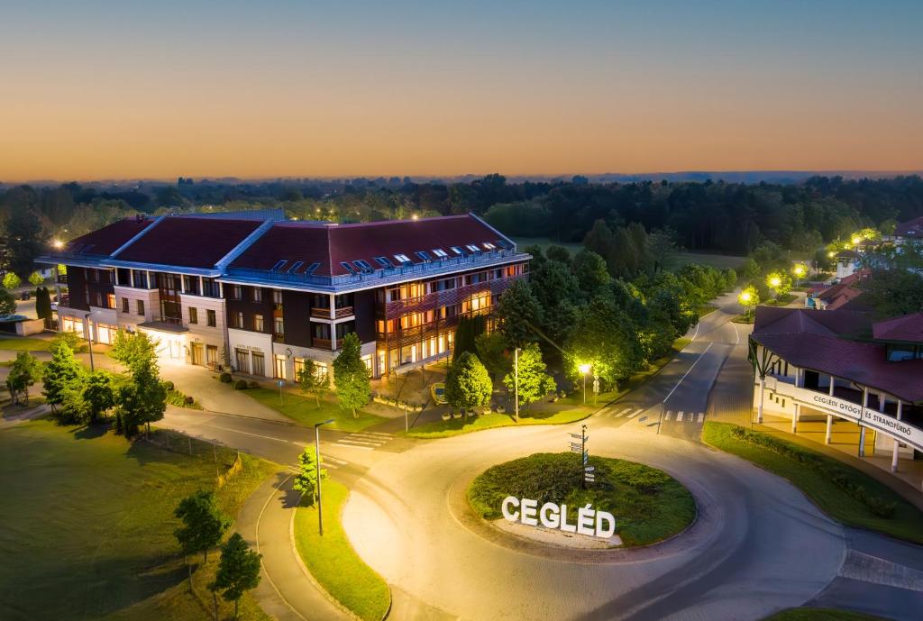 an aerial view of a building at night at Aquarell Hotel in Cegléd
