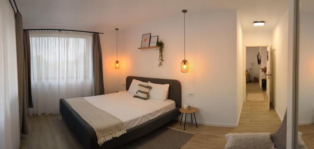 a bedroom with a bed and a hallway at Sibiu City Lights in Şura Mare