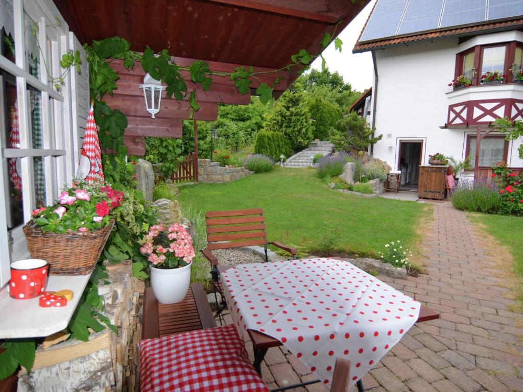 a patio with a table and chairs and a yard at Quaint Apartment in Zeil am Main with Terrace in Zeil