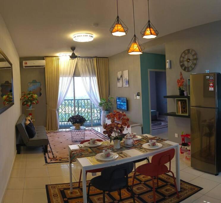 a kitchen and living room with a table and chairs at ER Homestay 2R1B suite nearby KLIA Terminal in Sepang