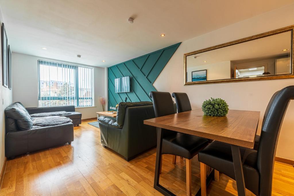 a living room with a table and a couch at Central Oasis, Serene Convenient 2-Bedroom Haven in L1 in Liverpool