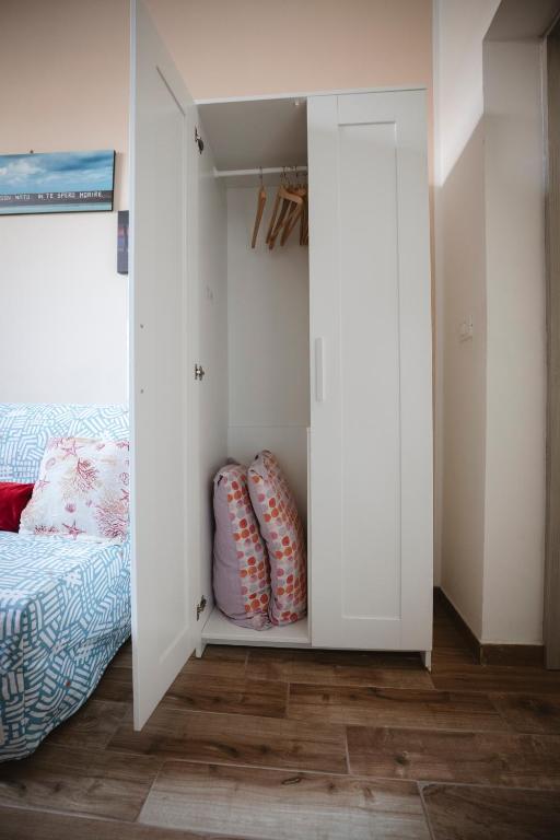 a bedroom with a bed and a white closet at Villa Valentina Versilia in Viareggio