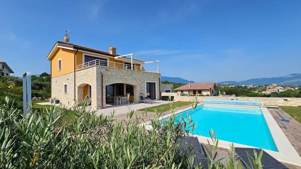 a villa with a swimming pool and a house at Casa dell’ Orso in Abbateggio