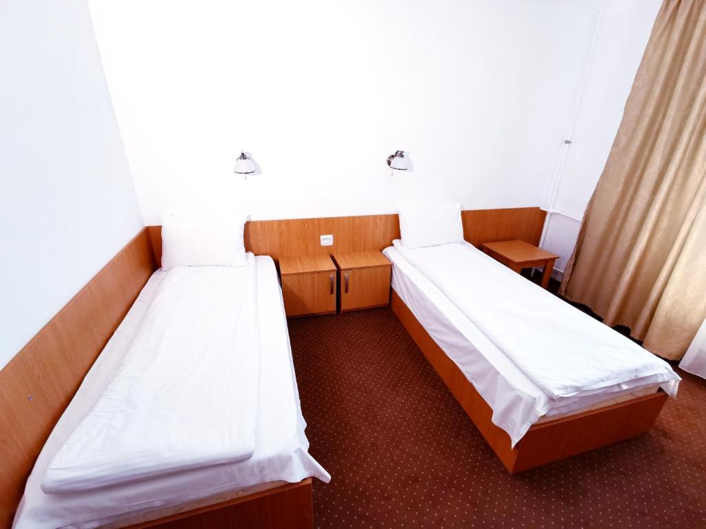 Postel nebo postele na pokoji v ubytování Hotel Muncel Băile Felix