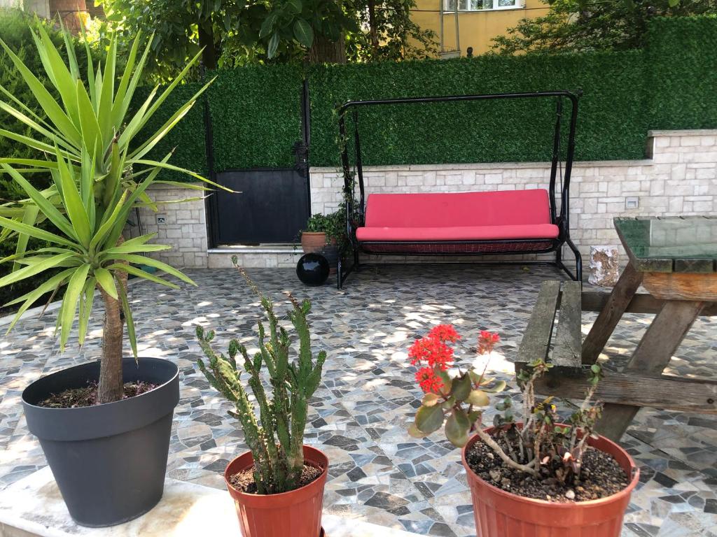 a pink bench in a courtyard with potted plants at Garden House in Istanbul