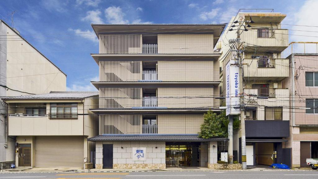 a tall building with a sign on the side of it at Toyoko Inn Kyoto Gojo omiya in Kyoto