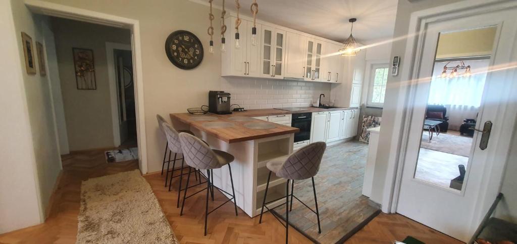 a kitchen with a island with bar stools in it at Dream Apartment Timisoara in Timişoara