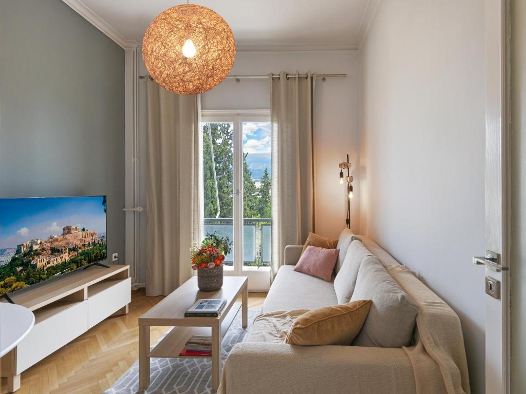 a living room with a couch and a tv at BeautIful apartment in Kolonaki in Athens