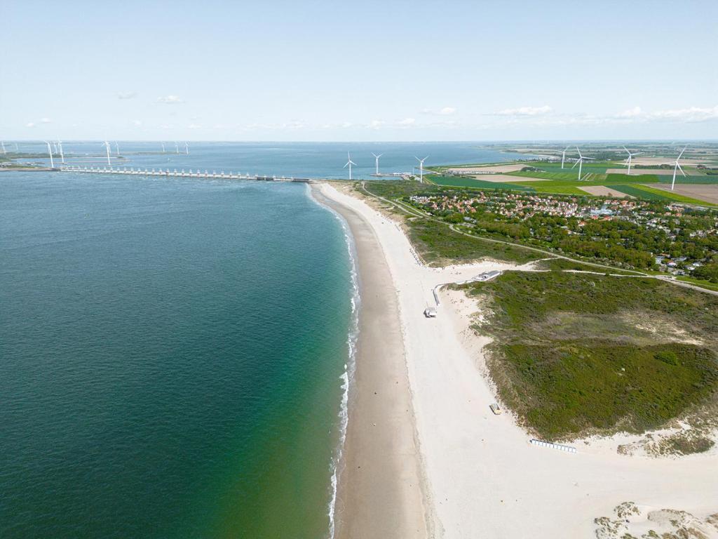an aerial view of a beach with windmills at Glamping Kamperland in Kamperland