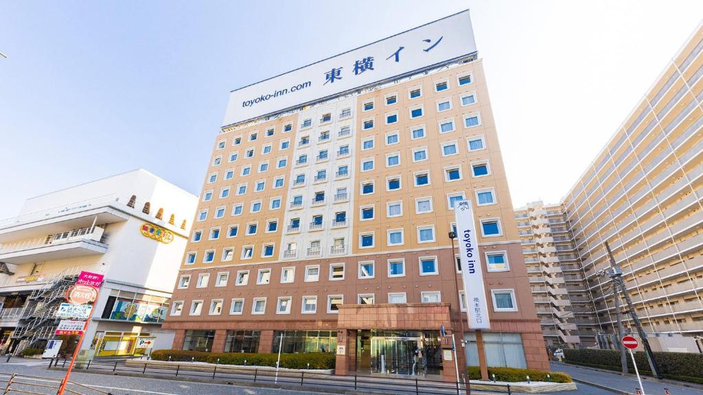 a large building with a sign on top of it at Toyoko Inn Keio sen Hashimoto eki Kita guchi in Sagamihara