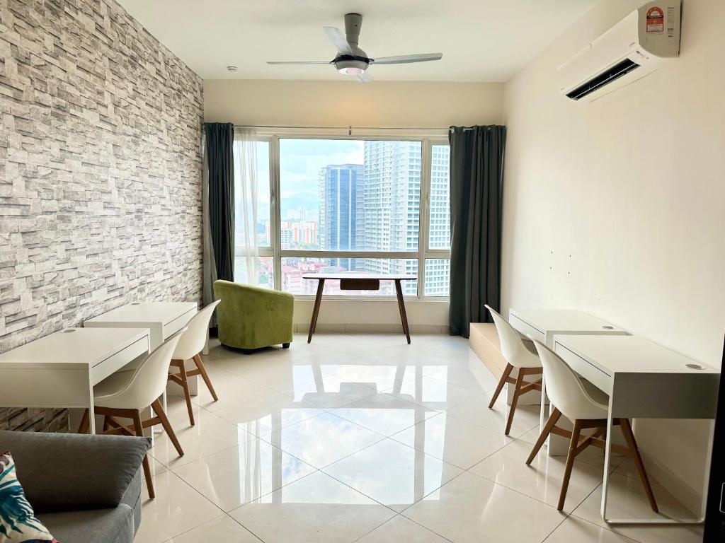 um restaurante com mesas e cadeiras e uma grande janela em Comfy+ by ARH KLCC em Kuala Lumpur
