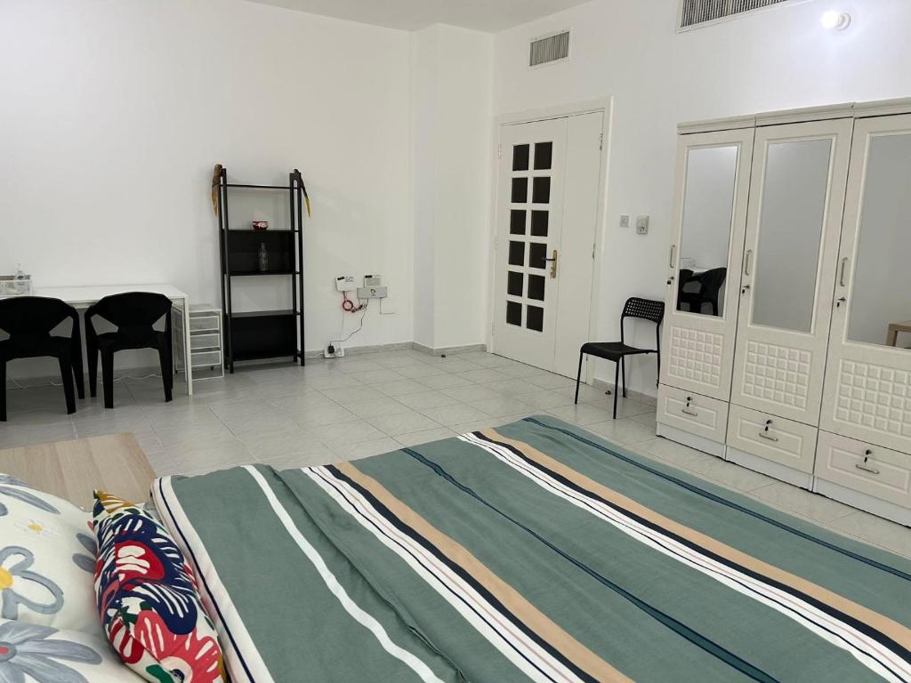 a bedroom with a bed and chairs in a room at Abu Dhabi Downtown 3 bedroom Penthouse Apartment in Abu Dhabi