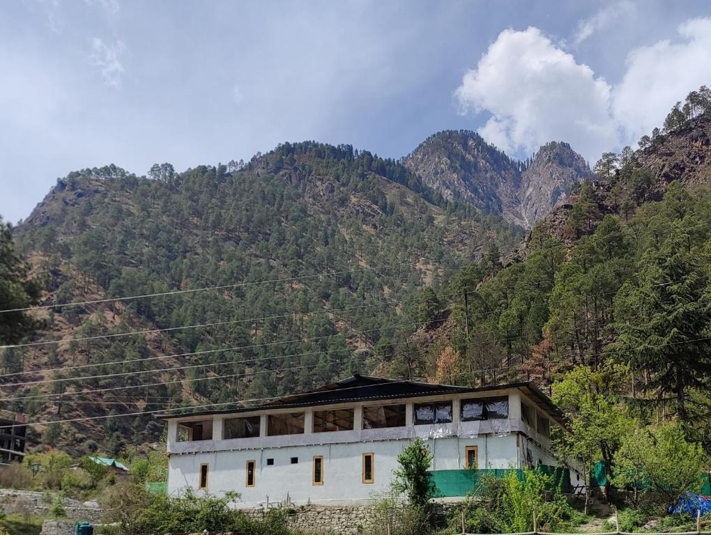 a building in front of a mountain at Circle Square in Kasol