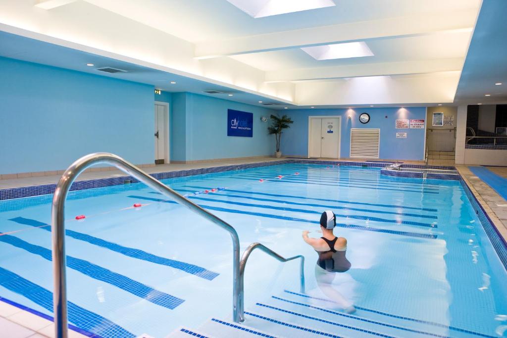 a woman in a swimming pool at City Hotel in Derry Londonderry