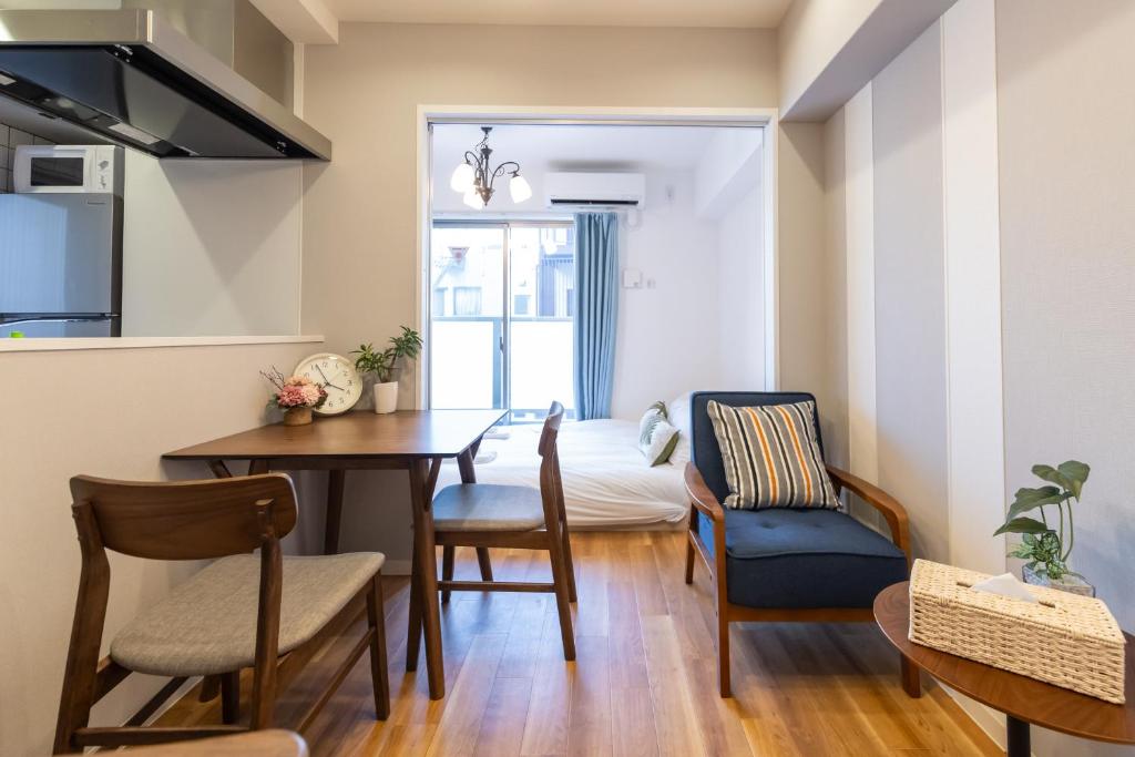a kitchen and dining room with a table and chairs at H2H Tsutenkaku in Osaka