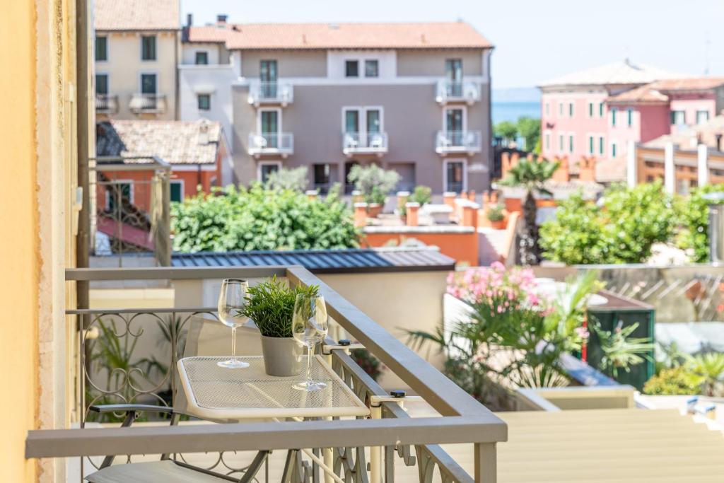 a balcony with a table and a view of a city at Palazzo Betteloni in Bardolino