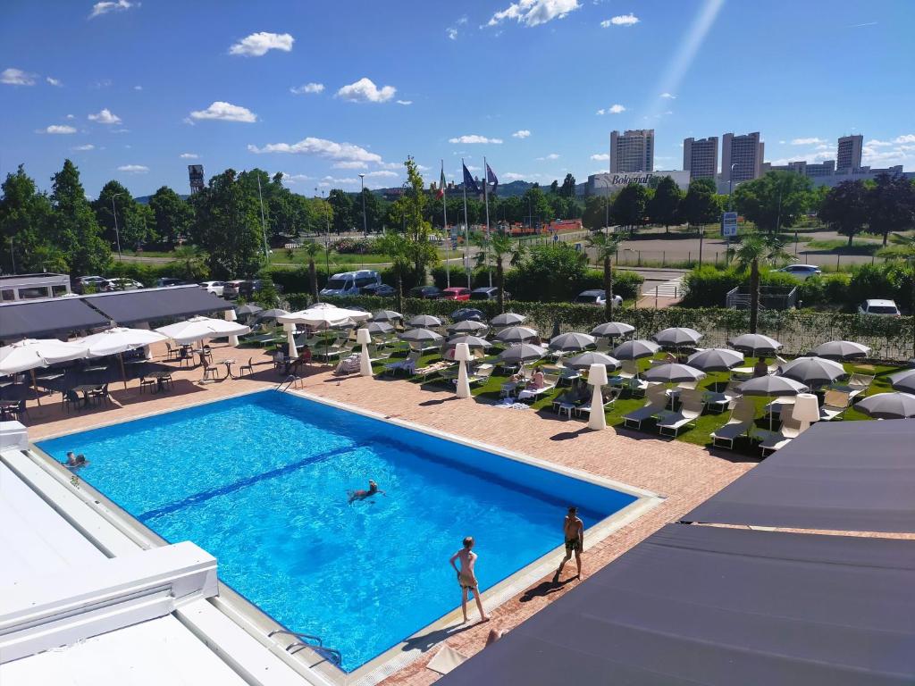 an overhead view of a swimming pool with umbrellas at The Sydney Hotel in Bologna