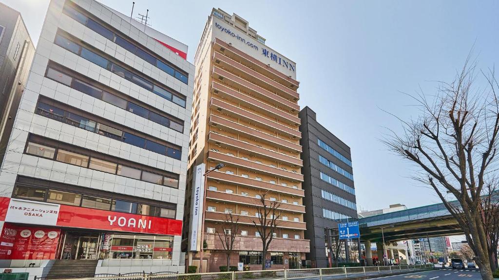 a tall building on the side of a street at Toyoko Inn Osaka Umeda Nakatsu No.2 in Osaka