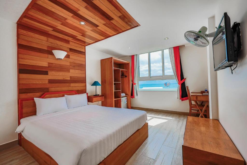 a bedroom with a bed and a television in it at Light House Phú Quốc in Phu Quoc