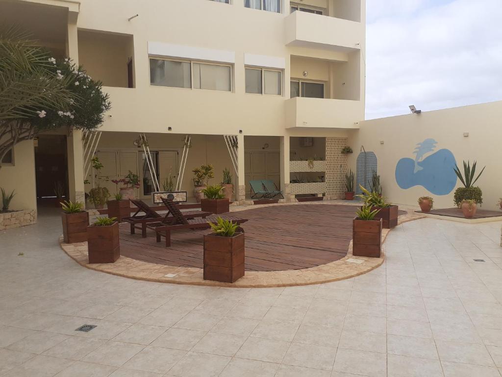 a large courtyard with potted plants in front of a building at S4A Trilocale vista Mare in Sal Rei