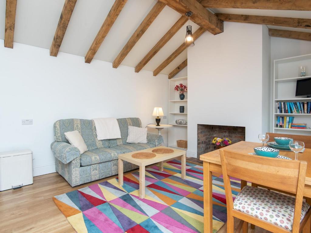 a living room with a couch and a table at Pass the Keys Charming Garden cottage with parking in Bath