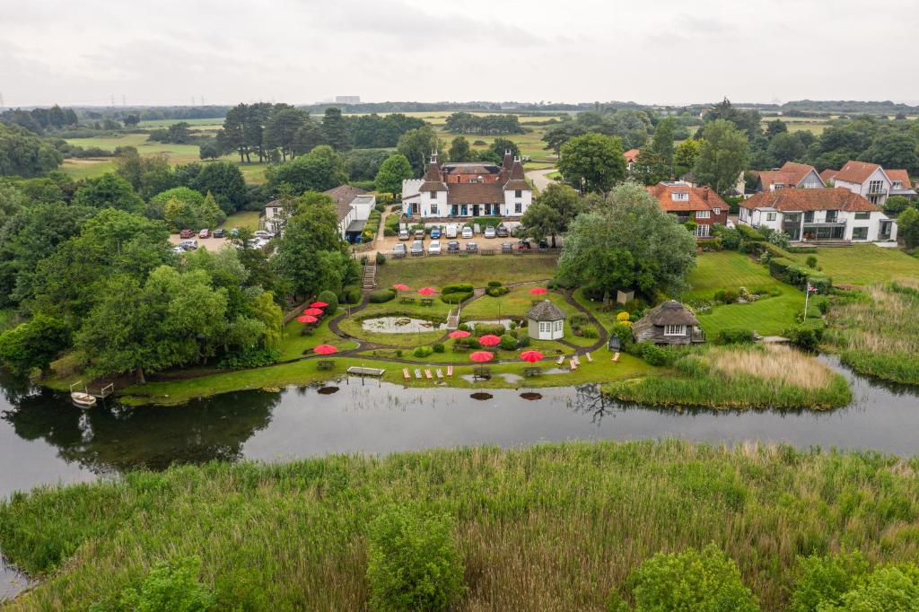 an island in the middle of a river with houses at Thorpeness Golf Club and Hotel in Thorpeness