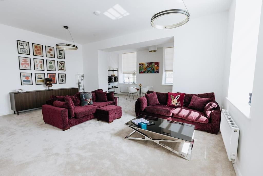 a living room with two purple couches and a table at BOBIN ROW - Grade 2 Listed Property with a Beautiful Design with Access to Leeds in Leeds