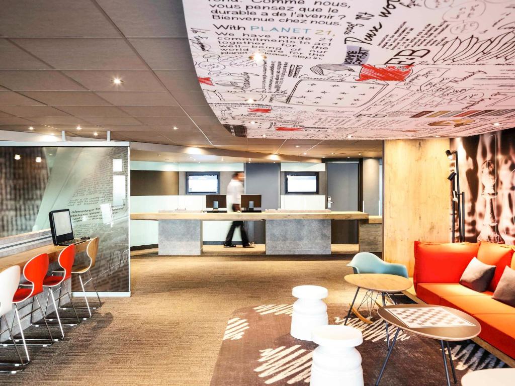an office with writing on the ceiling and tables and chairs at ibis Montpellier Centre Comedie in Montpellier