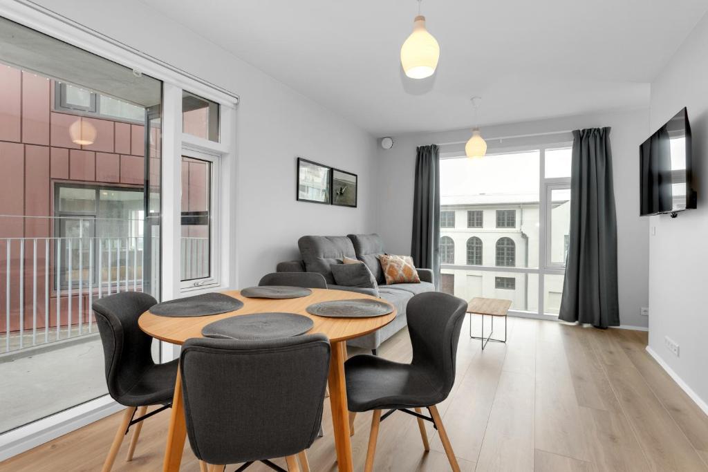 a living room with a table and chairs and a couch at Central Studio Apartment in Reykjavík