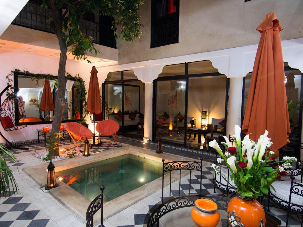 a swimming pool in the middle of a house at Riad Le Bel Oranger in Marrakesh