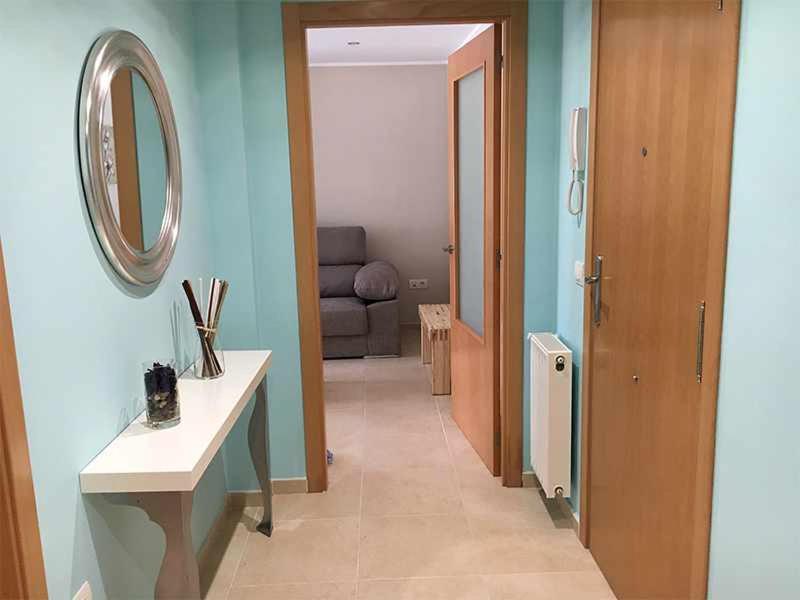 a room with a hallway with a table and a mirror at AP. FORCELLEDO in Posada de Llanes