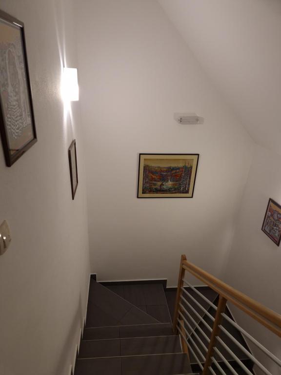 a staircase with a light and a picture on the wall at Guest house Wolf II in Plitvička Jezera