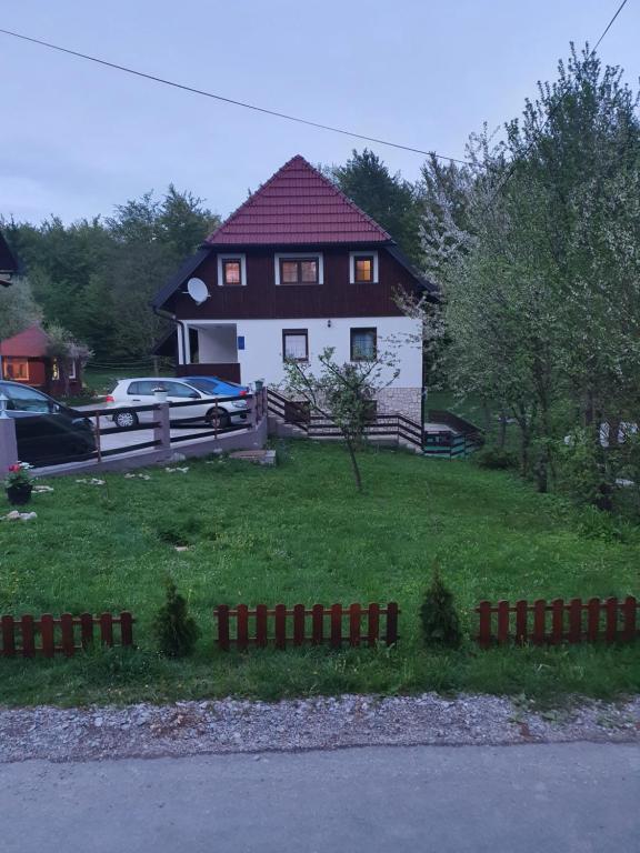 a house with a fence in front of it at Guest house Wolf II in Plitvička Jezera