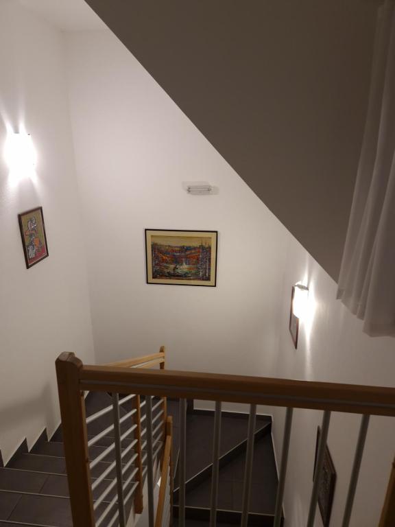 a staircase with two lights on a white wall at Guest house Wolf II in Plitvička Jezera