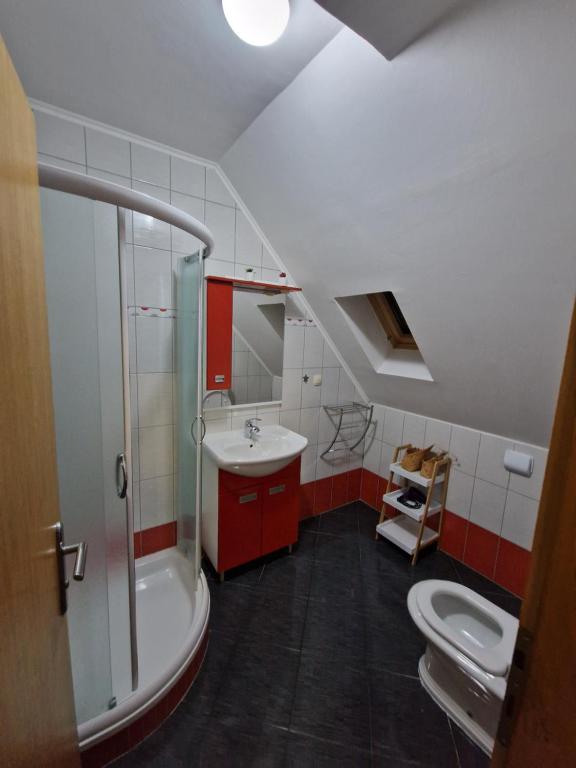 a bathroom with a sink and a tub and a toilet at Guest house Wolf II in Plitvička Jezera