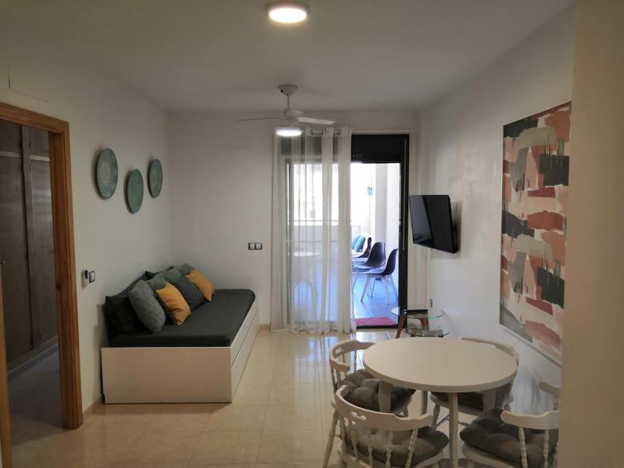 a living room with a couch and a table at Las Colinas, Envia Golf - Piscina & Gym in La Envia