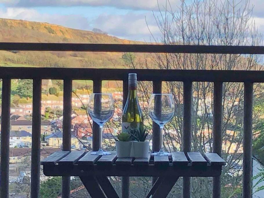 a table with two wine glasses and a bottle of wine at 2 Dorset Mews in Lyme Regis