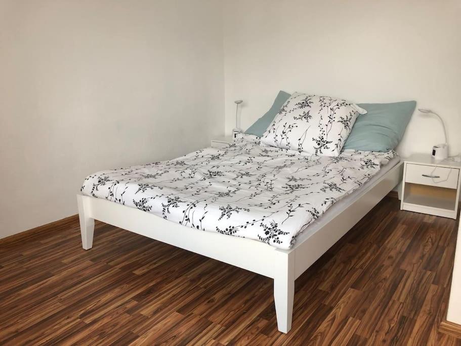 a bed in a room with a white at Family House Bibertal in Bibertal 