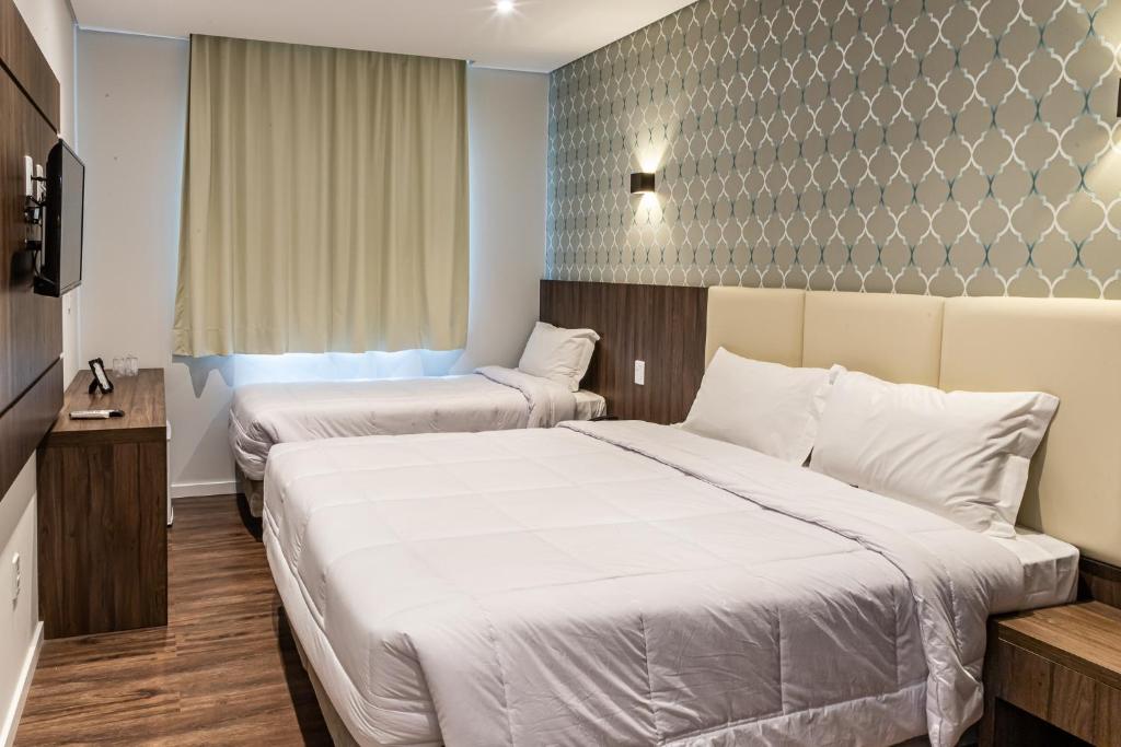 Cama ou camas em um quarto em Colina Lagos Hotel