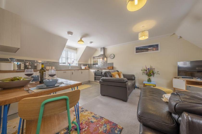 a living room with a couch and a table at The Coach House W in Wells next the Sea